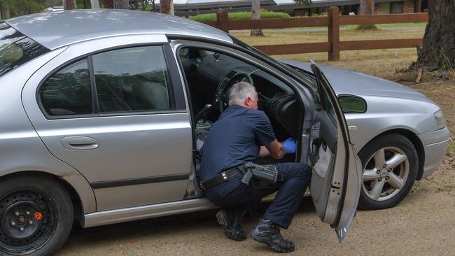 Police inspect the allegedly stolen car. Picture: Jason Edwards