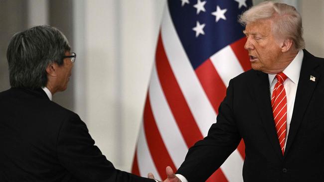 US President Donald Trump, right, greets LA Times owner Patrick Soon-Shiong ahead of a state dinner at the Lusail Palace in Doha on May 14, 2025. Picture: Brendan Smialowski/AFP.