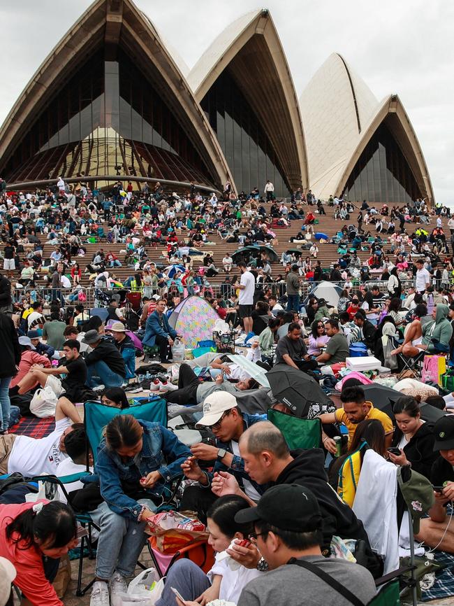 Crowds gather at Sydney Opera House ahead of New Year's Eve celebrations. (Photo by Roni Bintang/Getty Images)