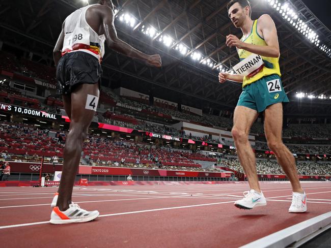 Patrick Tiernan bravely crosses the finish line in the men’s 10,000m last night. Picture: Getty Images