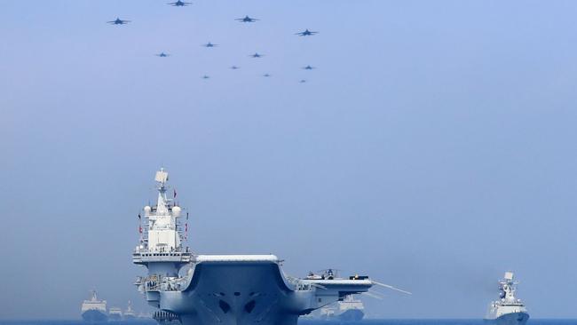 Chinese warships and fighter jets take part in a military display in the South China Sea in April. Picture: Reuters