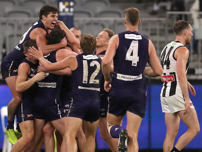 PERTH, AUSTRALIA - AUGUST 02: Team get around David Mundy of the Dockers after kicking the winning goal during the round nine AFL match between the Fremantle Dockers and the Collingwood Magpies at Optus Stadium on August 02, 2020 in Perth, Australia. (Photo by Paul Kane/Getty Images)