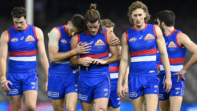 Marcus Bontempelli consoles Josh Bruce after he injured his knee. Picture: Quinn Rooney/Getty Images