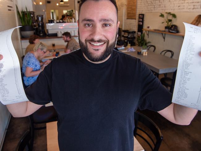 Gab Donoudis, owner of cafe OneThirtyTwo, has witnessed a lot of bill anxiety and uneasy customers when it comes to pay. Gab with a bill.Picture Jay Town