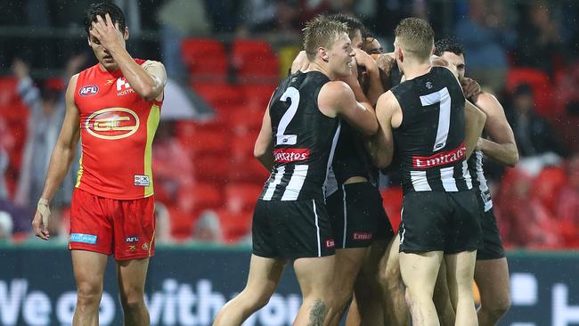 Collingwood players celebrate the win over Gold Coast.
