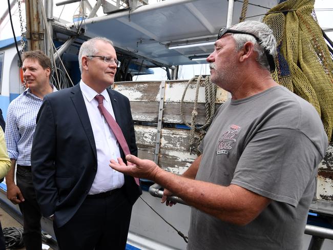 Scott Morrison hears from prawn fisherman Ted Woodham during a visit to the Morton Bay Boat Club in Brisbane. Picture: Dan Peled