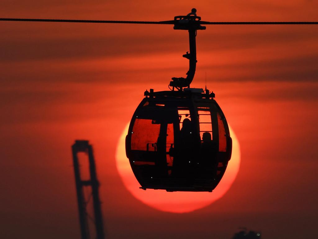 A silhouetted cable car is seen in front of the setting sun in Singapore on January 31, 2018. Picture: AFP