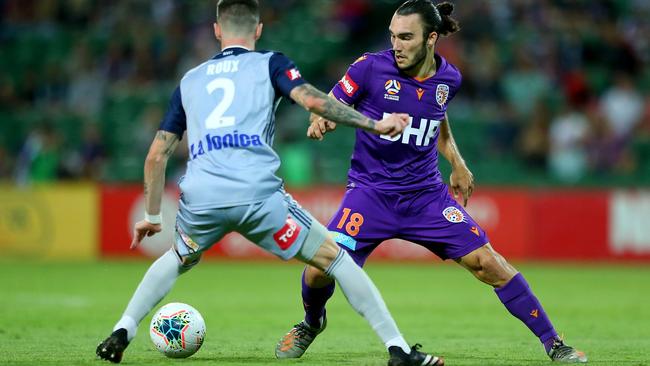 Nicholas D'Agostino, right, of the Perth Glory tries to make his way around Storm Roux of Melbourne Victory during the round-17 A-League match at HBF Park on Saturday. Picture: Getty Images