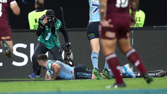 Photograph by Brett Costello showing Phil Hillyard shoot Tedesco and his match-winning try.