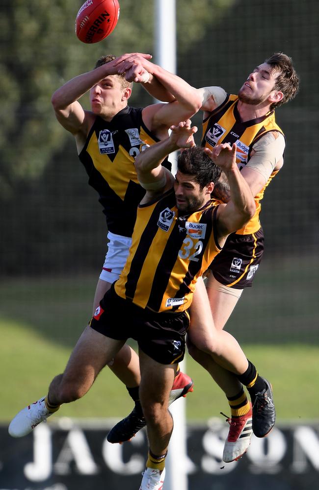 Joshua Corbett, Kaiden Brand and David Mirra collide in a marking contest. Picture: Andy Brownbill