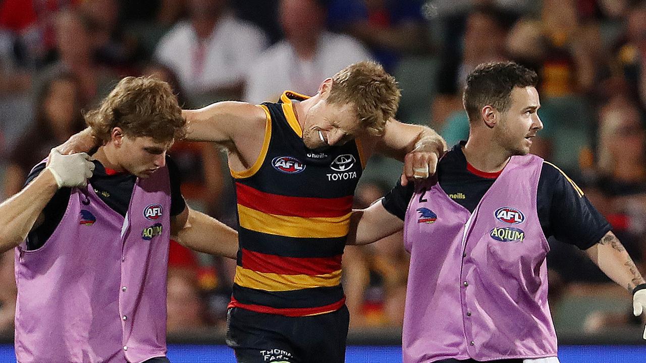 Rory Sloane grimaces in pain as he comes off the field after suffering his knee injury. Picture: AFL Photos via Getty Images