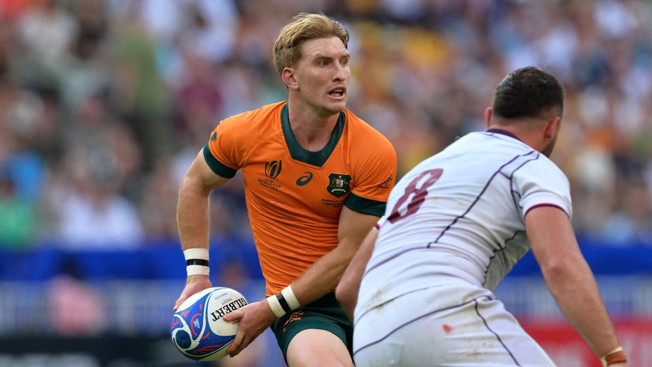 Australia's scrum-half Tate McDermott (L) runs with the ball during the France 2023 Rugby World Cup Pool C match between Australia and Georgia at Stade de France in Saint-Denis, on the outskirts of Paris, on September 9, 2023. (Photo by Miguel MEDINA / AFP)