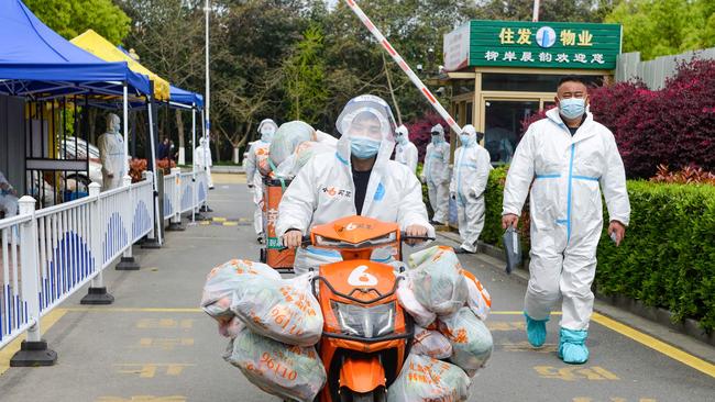 A delivery man wearing personal protective equipment delivering food bought for residents who were restricted due to a recent Covid-19 coronavirus outbreak in China. Picture: AFP