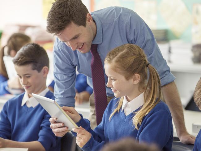 istock image lf teacher and pupils in classroom