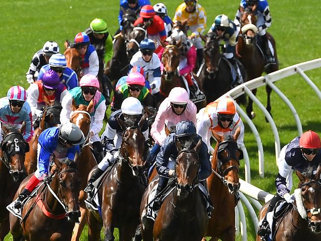 MELBOURNE, AUSTRALIA - NOVEMBER 03: Jye McNeil riding Twilight Payment leads the field around the first bend in the Lexus Melbourne Cup during 2020 Lexus Melbourne Cup Day at Flemington Racecourse on November 03, 2020 in Melbourne, Australia. (Photo by Quinn Rooney/Getty Images for the VRC)