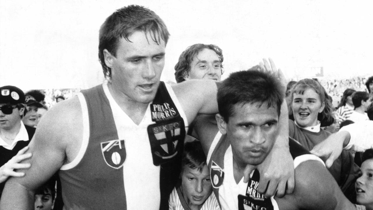 Tony Lockett and Nicky Winmar are mobbed by fans after a St Kilda win.