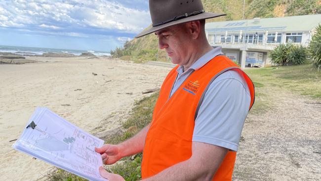 Nambucca Valley Council engineering assistant Ben Fuller inspects plans for the 180-metre concrete seawall at Main Beach, Nambucca Heads. Picture: Chris Knight