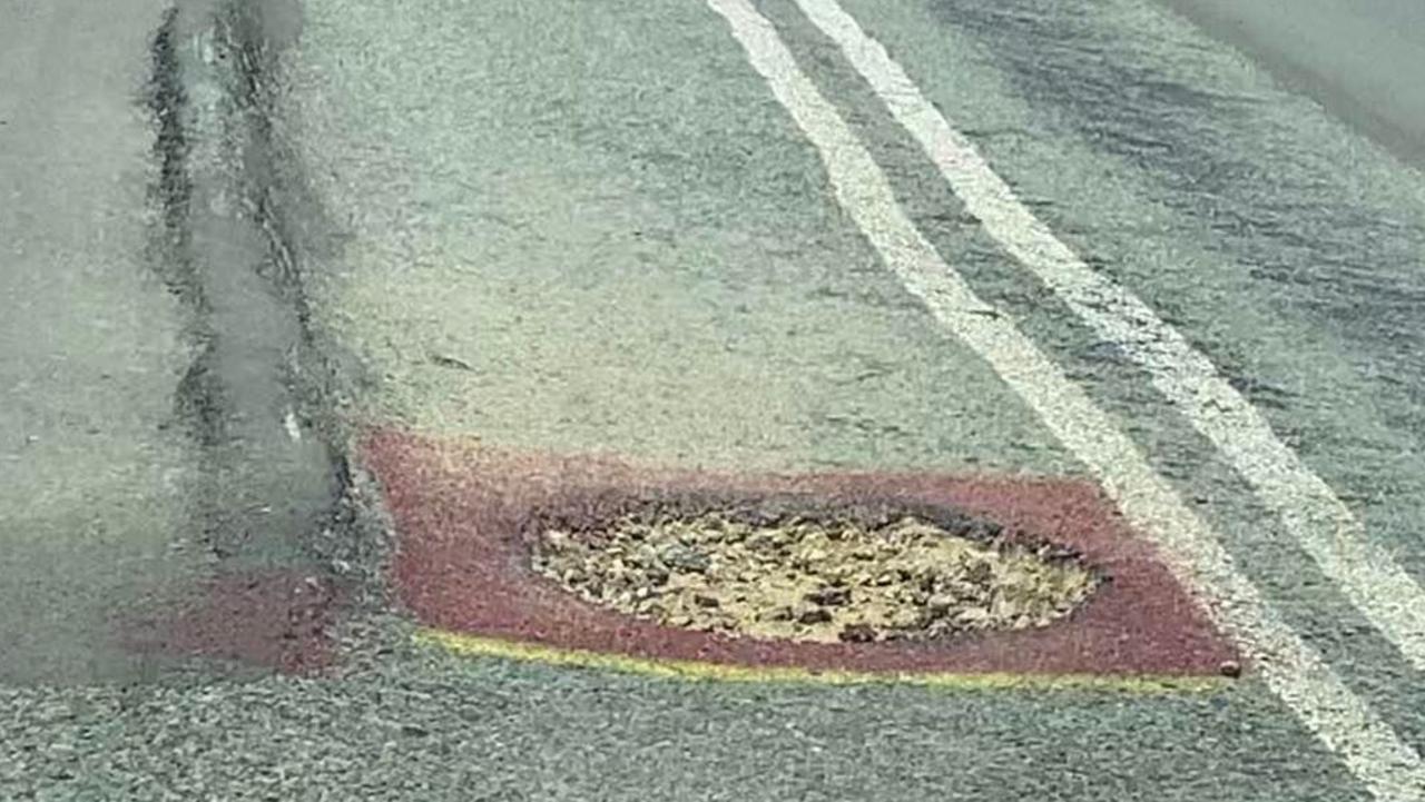 Several potholes have been painted red to warn drivers of the dangers on Curra Estate Rd.