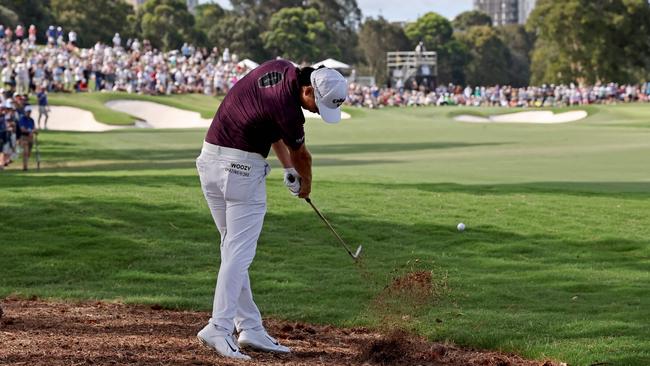 Min Woo Lee hits a stunning iron shot off the pine straw to set up eagle at the par-5 18th at The Australian. Picture: AFP.