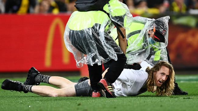 A pitch invader is tackled by security. Picture: Getty