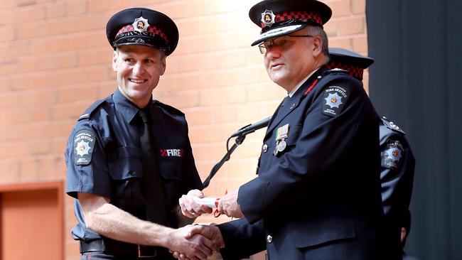 Short stay ... Kane Cornes is congratulated by chief fire officer Greg Crossman as he graduates from Metropolitan Fire Service training in September last year. Picture: Mike Burton