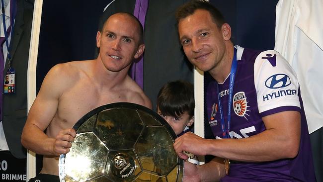 Perth Glory’s Neil Kilkenny (left) and Brendon Santalab celebrate after securing the A-League Premiers’ Plate at the weekend. 