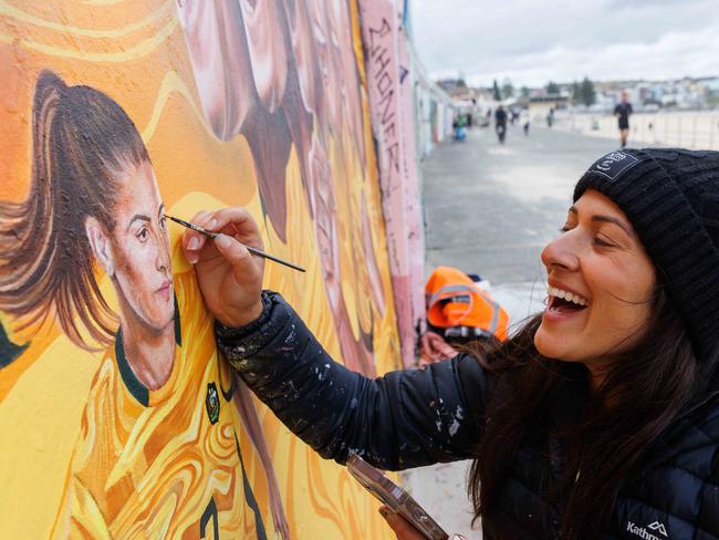 SYDNEY, AUSTRALIA - NewsWire Photos AUGUST 6, 2023: Melbourne Artist Danielle Weber is painting a mural of the Matildas on the the Bondi Beach front walk. Picture: NCA NewsWire / David Swift