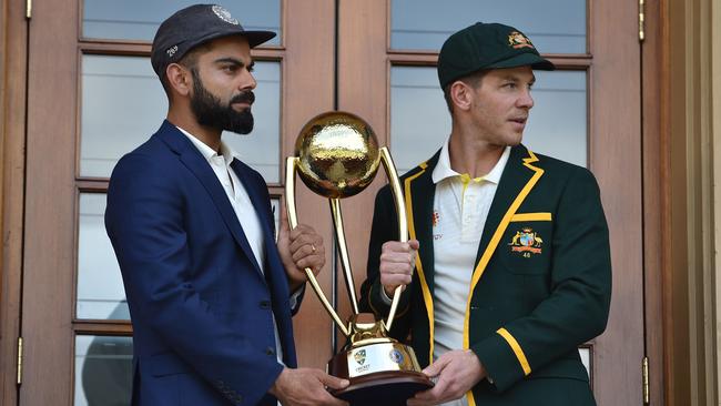 Australia cricket captain Tim Paine, right, and India cricket captain Virat Kohli pose with the Border Gavaskar trophy. Picture: AFP