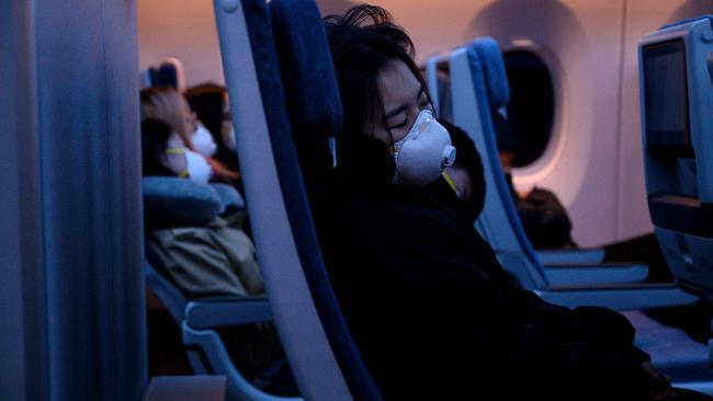 Rules on face masks during flights are all over the shop creating confusion for passengers. Picture: Noel Celis/AFP