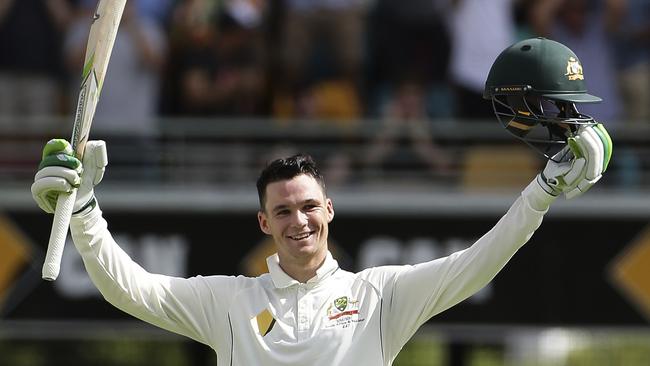 Australia's Peter Handscomb celebrates bringing up his century at the Gabba on Friday.