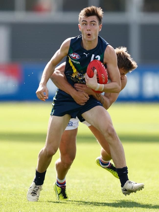 Jagga Smith of the AFL Academy is tackled during the 2024 AFL Academy match between the Marsh AFL National Academy Boys and Footscray Bulldogs at Whitten Oval. Picture: Michael Willson/AFL Photos via Getty Images