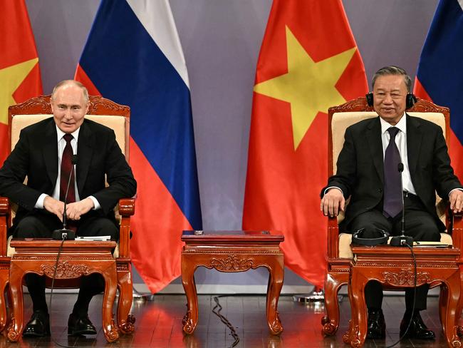 Russia's President Vladimir Putin (L) and Vietnam's President To Lam (R) take part in an event attended by the Vietnam Friendship Association and generations of Vietnamese alumni that studied in Russia at the Hanoi Opera House in Hanoi on June 20, 2024. (Photo by Manan VATSYAYANA / POOL / AFP)