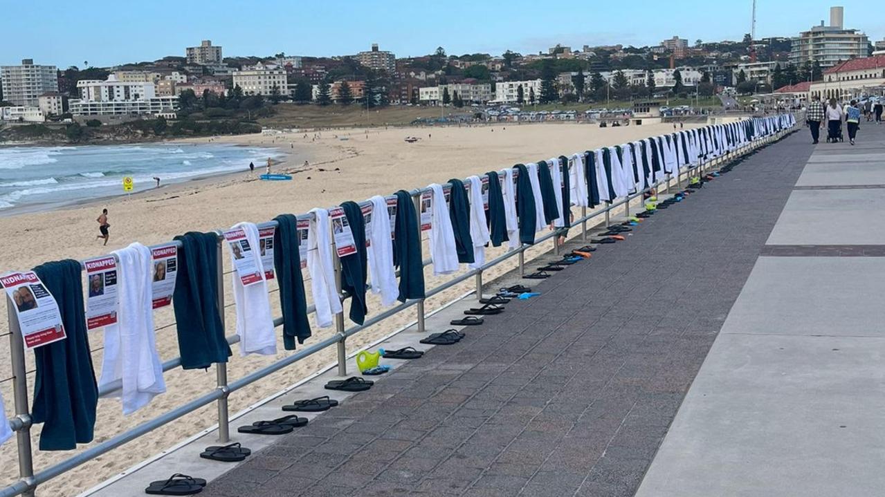 The vigil at Bondi Beach laid out posters, thongs and towels for all of the Israeli civilians kidnapped by Hamas. Picture: Supplied