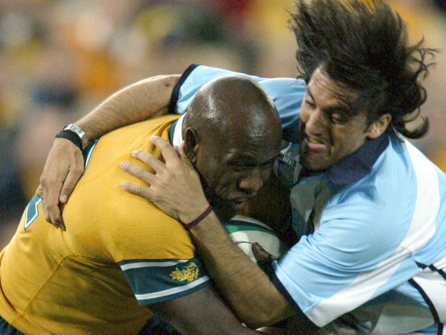 ## HAVE YOU /CHECKED COPYRIGHT /CLEARANCE ?? RWC Rugby World Cup Aust Wallabies vs Argentina at Telstra Stadium. Aust's Wendell Sailor fights through the tackle of Agustin Pichot 10 Oct 2003 PicColleen/Petch sport union action