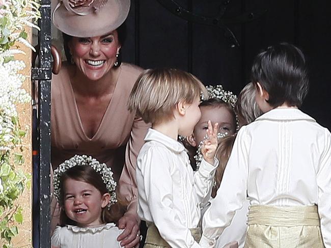 Kate, Duchess of Cambridge, left, stands with her daughter Princess Charlotte, bottom left, as they arrive for the wedding of Pippa Middleton and James Matthews at St Mark's Church in Englefield Saturday, May 20, 2017. Middleton, the sister of Kate, Duchess of Cambridge is to marry hedge fund manager James Matthews in a ceremony Saturday where her niece and nephew Prince George and Princess Charlotte are in the wedding party, along with sister Kate and princes Harry and William. (AP Photo/Kirsty Wigglesworth, Pool)