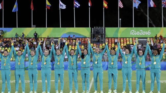 Australia's players celebrate at the medal ceremony.