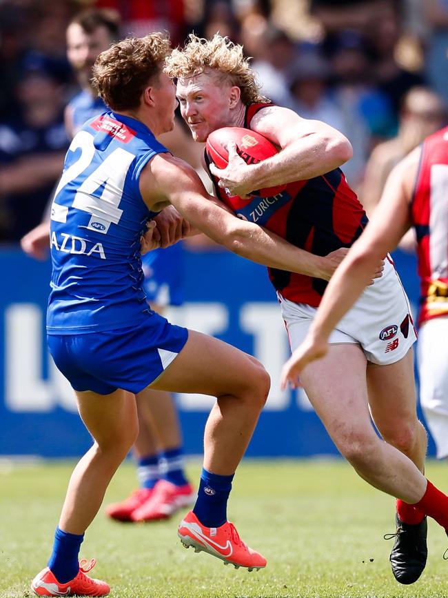 Clayton Oliver pushes past North Melbourne’s Tom Powell. Picture: Dylan Burns/AFL Photos