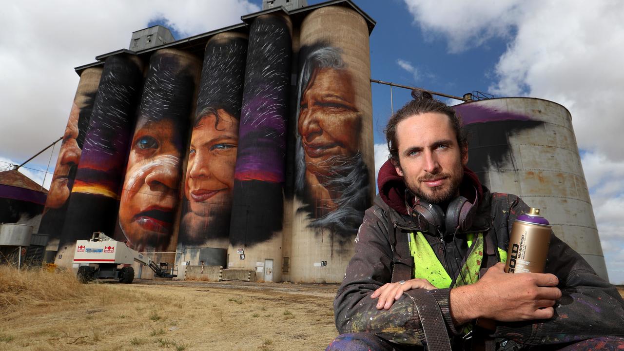 Matt Adnate with his four 30m high silo artwork in the Victorian Wimmera wheat town of Sheep hills in late 2016. Picture: David Geraghty / The Australian