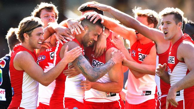 Teammates celebrate with Buddy after kicking a goal in his 300th game. Picture: Phil Hillyard