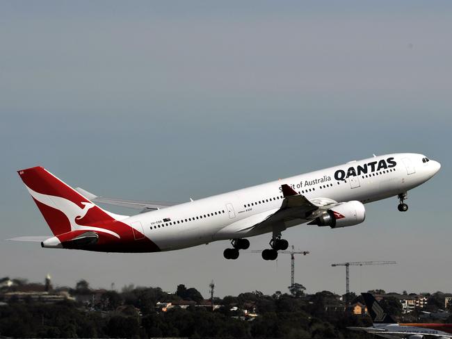 Qantas aircraft seen at Sydney International Airport, Sydney, Friday, Aug. 12, 2016. International air passengers are being warned of potential disruption and delays when union members in the Department of Immigration and Border Protection strike for 24 hours. (AAP Image/Joel Carrett) NO ARCHIVING