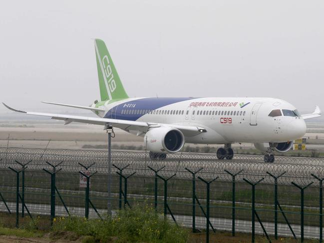 (FILES) This file photo taken on April 16, 2017 shows China's first big passenger plane, the C919, being given the first high-speed taxi test at Shanghai Pudong International Airport in Shanghai.  China is expected within days to carry out the maiden test flight of a home-grown passenger jet built to meet soaring Chinese travel demand and challenge the dominance of Boeing and Airbus. The C919, built by state-owned aerospace manufacturer Commercial Aircraft Corporation of China (COMAC), was set to take wing over Shanghai and could be cleared for takeoff as early as May 5, 2017, according to state media. / AFP PHOTO / STR / China OUT / TO GO WITH China-aviation-manufacturing, ADVANCER by Albee ZHANG