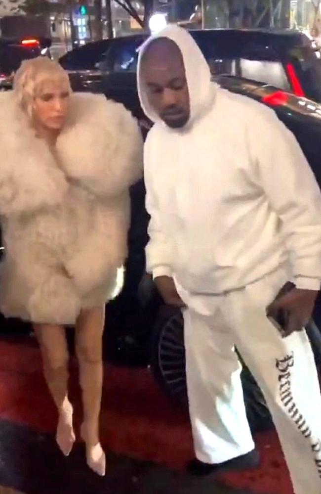 Kanye West stepped out in Tokyo with wife Bianca Censori, who wore very little under her giant fur coat. Picture: BACKGRID