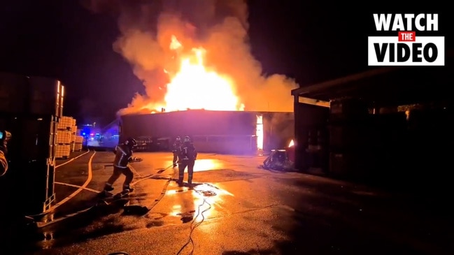 Dozens of firefighters battle factory blaze