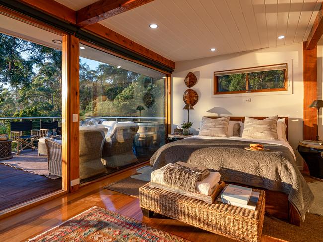 Huon River Hideaway’s cosy, welcoming bedroom which opens out to a sun-drenched deck. Picture: Jon Jarvela Photographs