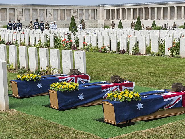 Coffins containing the remains of an unknown World War I digger are seen at a military funeral to lay the unknown soldiers to rest at the local war cemetery, Pozieres in northern France. Picture: AAP