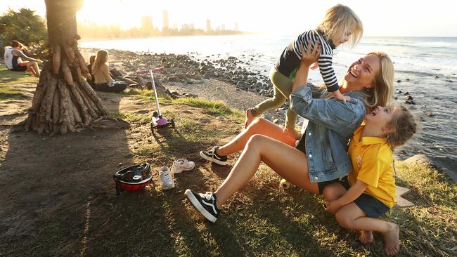 Dutch au pair Kim van der Jooij with Ellie, left, and Sophia at Burleigh Heads on the Gold Coast on Tuesday. Picture: Lyndon Mechielsen