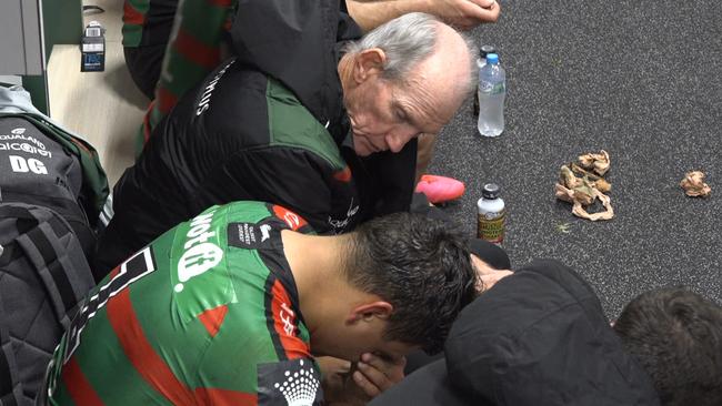 Latrell Mitchell receives support from Bunnies teammates and coach Wayne Bennett