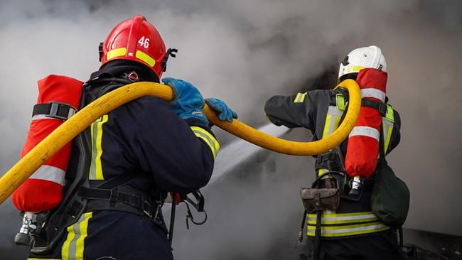 Firefighters work to extinguish a fire following a missile attack at an undisclosed location in Lviv region. More than a million Ukrainians were left without power in freezing cold temperatures on November 28. Picture: Handout/Ukrainian Emergency Service/AFP