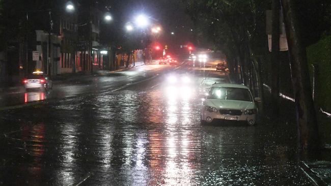 Police were required for point duty after Parramatta Rd at Forest Lodge was completely covered by water over the weekend. Picture: Gordon McComiskie