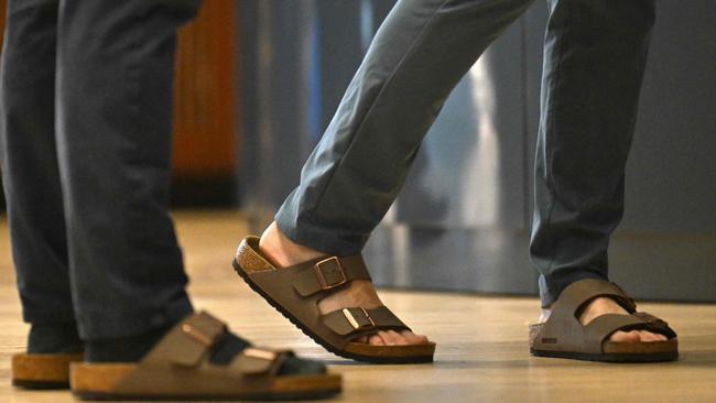 TOPSHOT - Traders wearing Birkenstock sandals work the floor at the New York Stock Exchange (NYSE) in New York on October 11, 2023, during Birkenstock's launch of an Initial Public Offering (IPO). German sandals maker Birkenstock has set its share price at $46, the firm said in a press release early Wednesday. A total of 32.26 million ordinary shares will be offered in its initial public offering, trading under the symbol BIRK. (Photo by ANGELA WEISS / AFP)